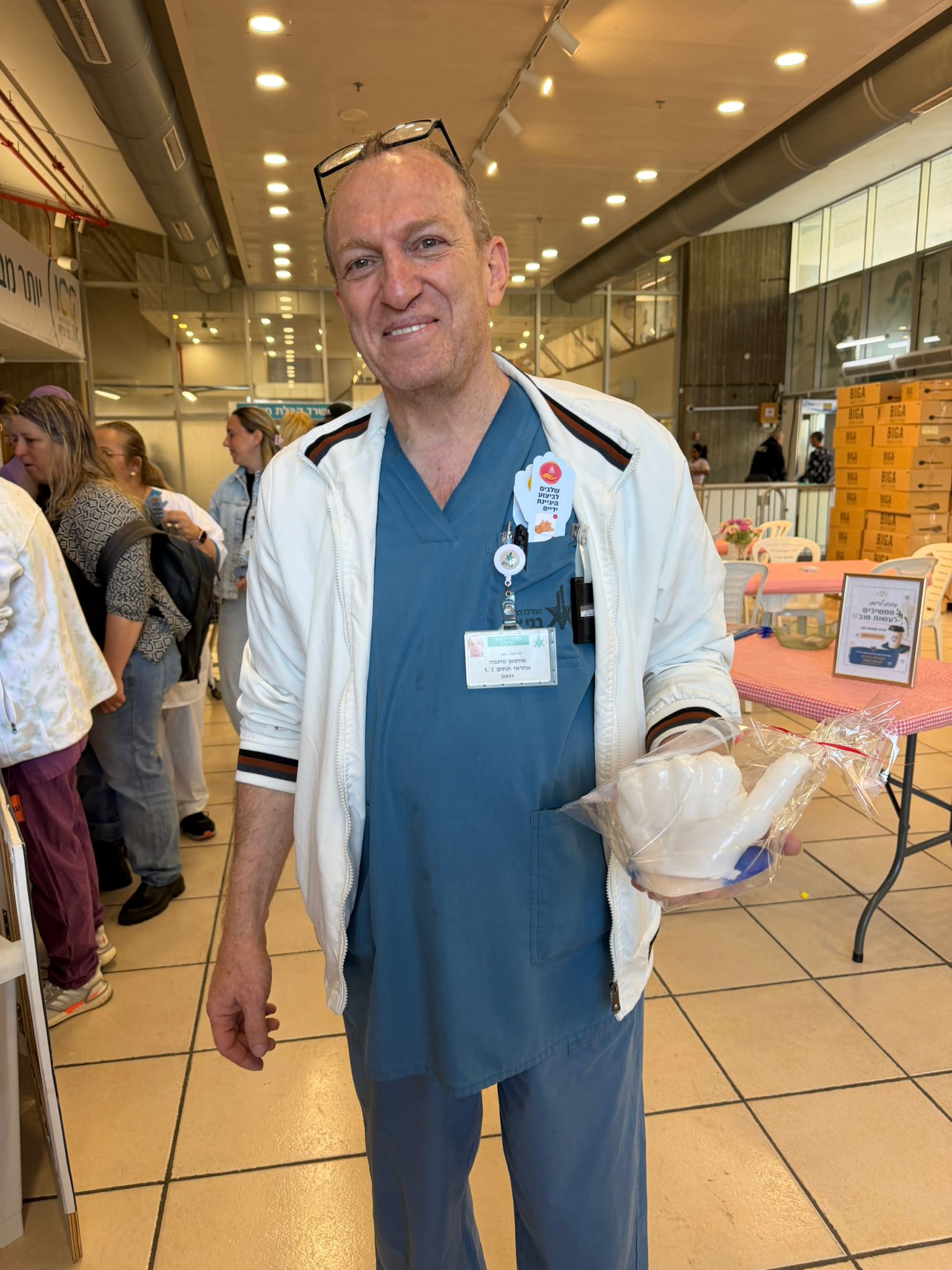 איש צוות רפואי עם יצירת יד השעווה שלו ביום גיבוש